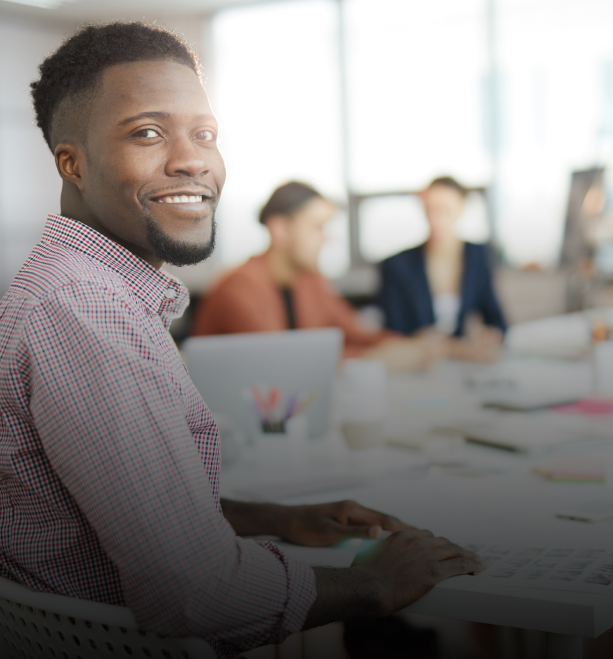 Smiling male leader in office environment