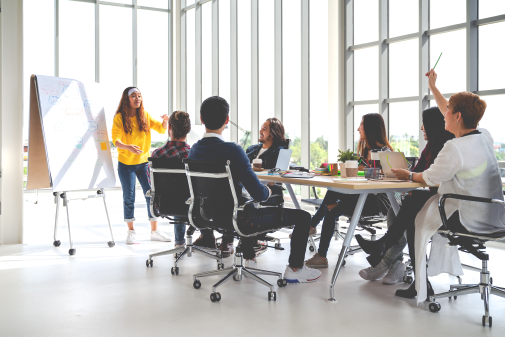 Woman leading a group of colleagues at large conference table